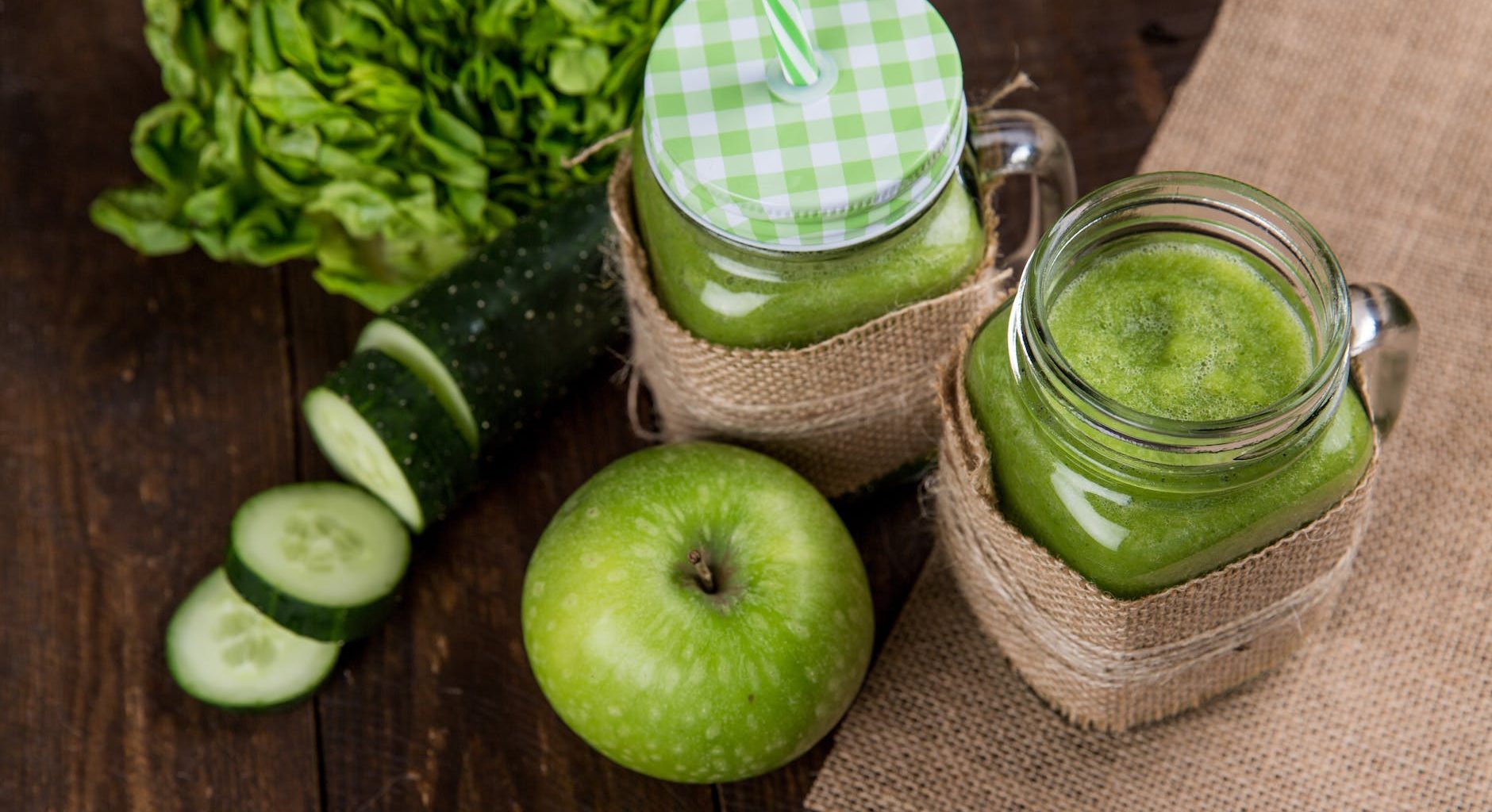 green apple beside of two clear glass jars