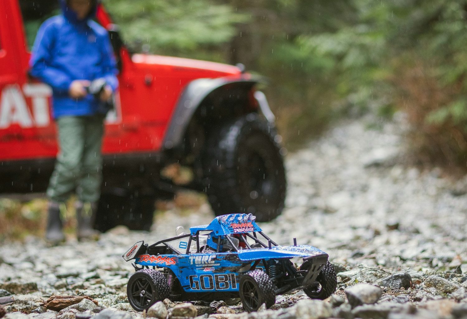 blue and black toy car on rocks
