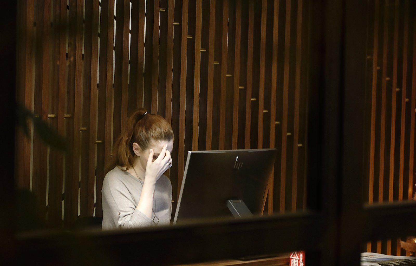 a woman sitting in front of a laptop computer