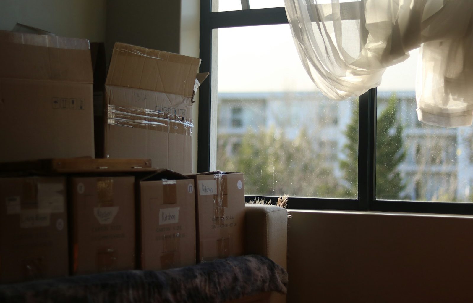 a room with boxes and a window