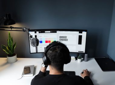 man in black shirt sitting in front of computer